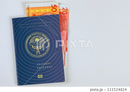 Money in Kyrgyzstan som banknotes in Kyrgyz Republic passport on white background 111524824