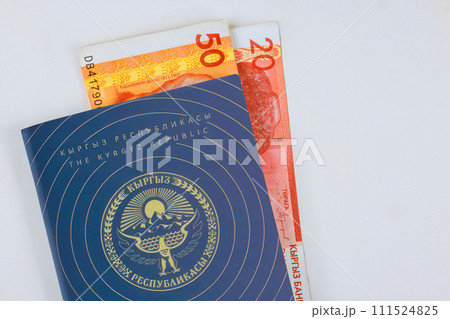Kyrgyzstan money som banknotes in Kyrgyz Republic passport at white background 111524825