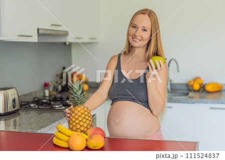 Embracing a healthy choice, a pregnant woman prepares to enjoy a nutritious moment, gearing up to eat fresh fruit and nourish herself during her pregnancy Embracing a healthy choice, a pregnant woman prepares to enjoy a nutritious moment, gearing up to eat fresh fruit and nourish herself during her pregnancy 111524837