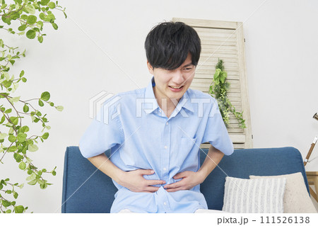リビングで腹痛の男性 リビングで腹痛の男性 111526138