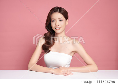 Beautiful young asian woman with clean fresh skin on pink background, Face care, Facial treatment, Cosmetology, beauty and spa, Asian women portrait. Beautiful young asian woman with clean fresh skin on pink background, Face care, Facial treatment, Cosmetology, beauty and spa, Asian women portrait. 111526790