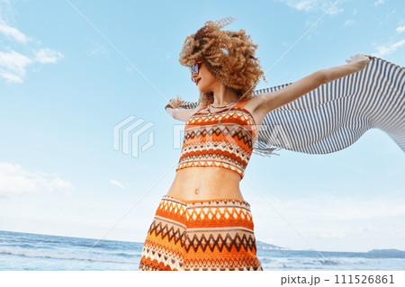 Smiling Woman Enjoying Carefree Summer Vacation on the Beach, Surrounded by Beautiful Nature and Sunlight 111526861