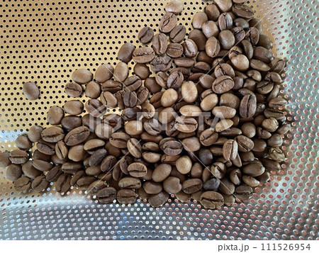 Roasted coffee beans on stainless steel grater 111526954