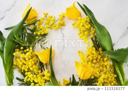 Mimosas and tulips frame on marble background 111528177
