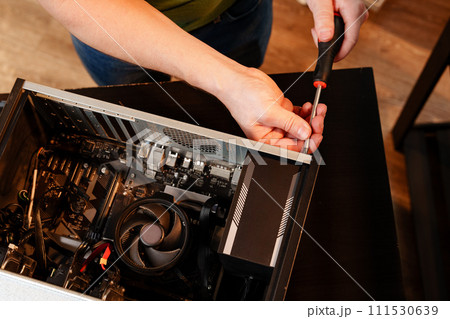 Close up of man repairing computer system unit 111530639