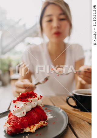 Cake being eat by woman in the cafe. Focus selective on the cake. 111531396