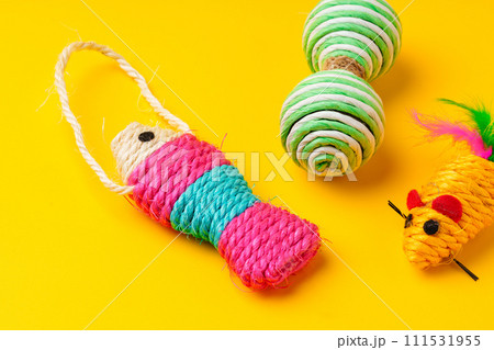 Pet toys on yellow background studio shot Pet toys on yellow background studio shot 111531955