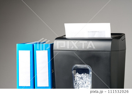 Office paper shredder on table against gray background 111532026