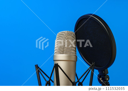 Professional microphone stand over blue studio background 111532035