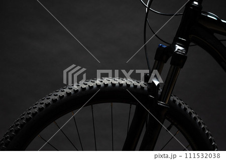 Close up of a bicycle against black background 111532038