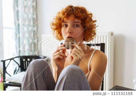 teenage girl eating cookies at home for breakfast teenage girl eating cookies at home for breakfast 111532108