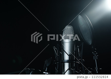 Professional microphone against black background in studio Professional microphone against black background in studio 111532814