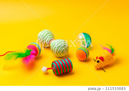 Pet toys on yellow background studio shot Pet toys on yellow background studio shot 111533083