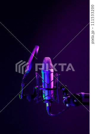 Professional microphone against black background in studio 111533200