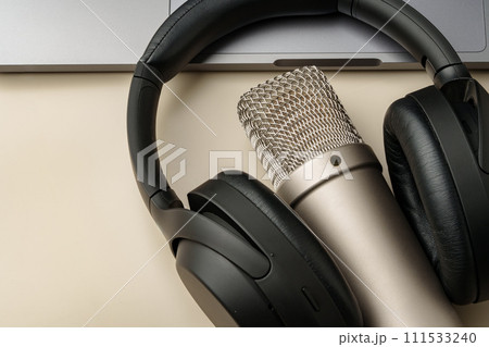 Headphones and microphone on the table close up Headphones and microphone on the table close up 111533240
