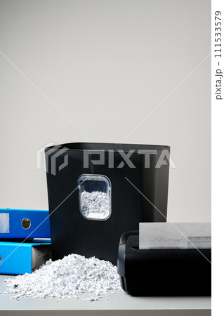 Office paper shredder on table against gray background 111533579