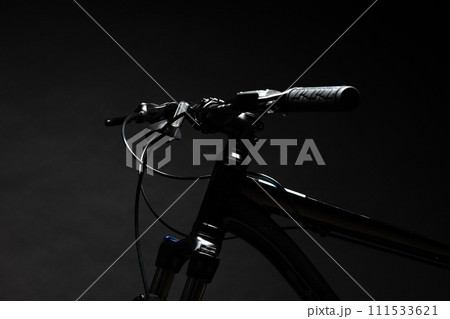 Close up of a bicycle against black background Close up of a bicycle against black background 111533621