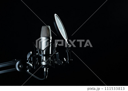 Professional microphone against black background in studio 111533813