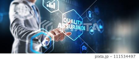 QA Businessman pressing Quality assurance button on virtual screens QA Businessman pressing Quality assurance button on virtual screens 111534497