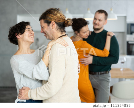 Men and women dancing during house party. 111534855