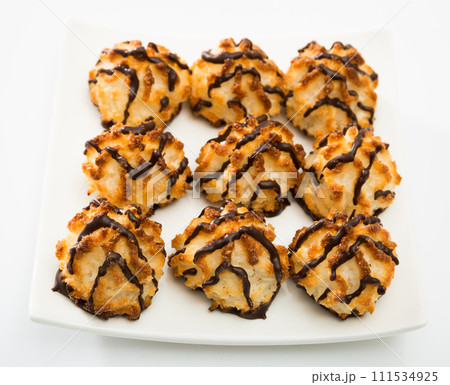 Baked coconut dessert on white plate Baked coconut dessert on white plate 111534925