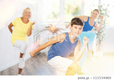 Happy preteen boy practicing dance positions during workout session Happy preteen boy practicing dance positions during workout session 111534960