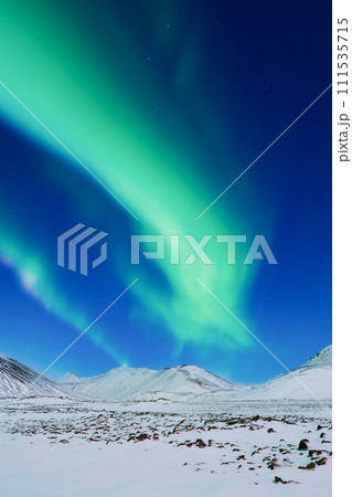 Aurora Borealis. Northern Lights over the mountains. A winter night landscape 111535715