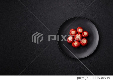 Red bell peppers stuffed with cheese or meat with salt, spices and herbs 111536549