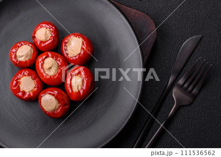 Red bell peppers stuffed with cheese or meat with salt, spices and herbs Red bell peppers stuffed with cheese or meat with salt, spices and herbs 111536562