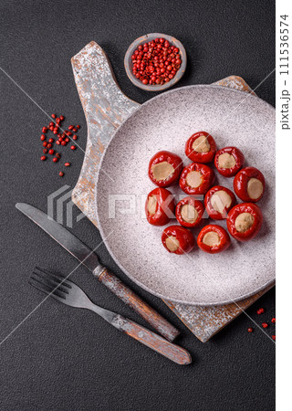 Red bell peppers stuffed with cheese or meat with salt, spices and herbs 111536574