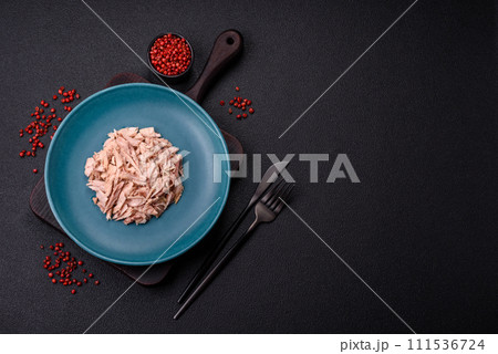 Delicious canned dietary tuna meat with salt, spices and oil 111536724