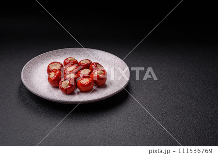 Red bell peppers stuffed with cheese or meat with salt, spices and herbs Red bell peppers stuffed with cheese or meat with salt, spices and herbs 111536769