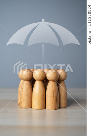 A group of people and an umbrella above. The concept of insurance and social protection. Life insurance. Customer care. Human resources. A group of people and an umbrella above. The concept of insurance and social protection. Life insurance. Customer care. Human resources. 111538924