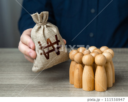 Man adjusts and south korean won money bag to a crowd of people. Financial support. Providing money, paying salaries and grants. Compensation payments. Social assistance to victims of conflict. Man adjusts and south korean won money bag to a crowd of people. Financial support. Providing money, paying salaries and grants. Compensation payments. Social assistance to victims of conflict. 111538947