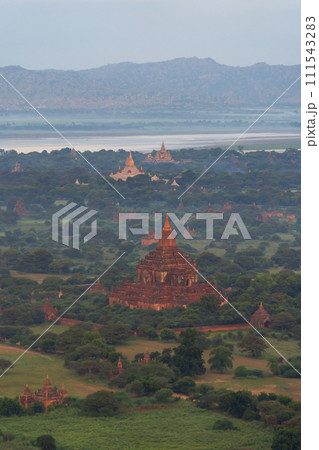 Aerial top view of burmese temples of Bagan City from a balloon, unesco world heritage with forest trees, Myanmar or Burma. Tourist destination. 111543283