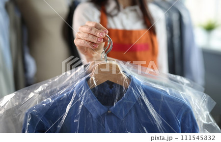 A woman holds men's clothes on her shoulders, blurry 111545832