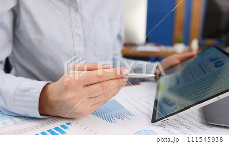 In female hands, a tablet with financial indicators, blurry In female hands, a tablet with financial indicators, blurry 111545938