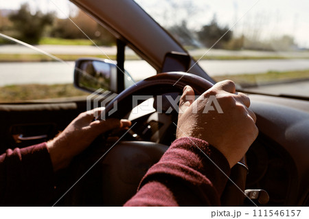 Close-up of a male hands on a steering wheel 111546157
