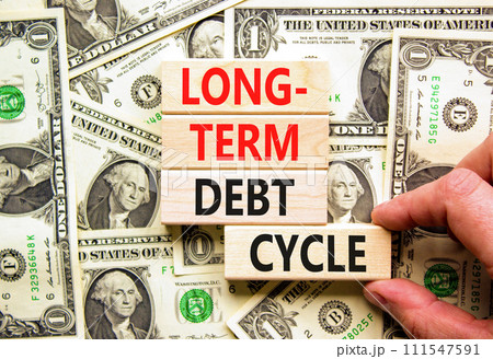 Long-term debt cycle symbol. Concept words Long-term debt cycle on beautiful wooden block. Beautiful dollar bills background. Dollar bills. Business Long-term debt cycle concept. Copy space 111547591