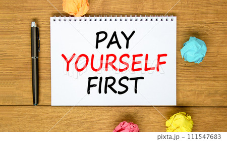 Pay yourself first symbol. Concept words Pay yourself first on beautiful white note. Beautiful wooden background. Black pen. Colored paper. Business and pay yourself first concept. Copy space. Pay yourself first symbol. Concept words Pay yourself first on beautiful white note. Beautiful wooden background. Black pen. Colored paper. Business and pay yourself first concept. Copy space. 111547683