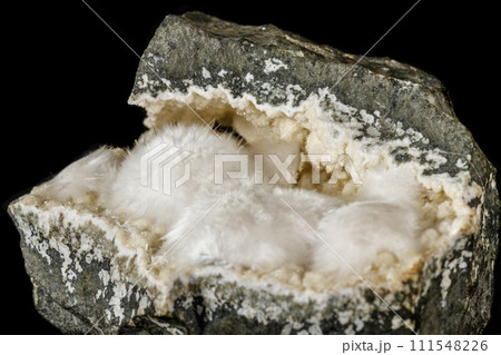Macro stone Stilbite mineral on white black close up 111548226