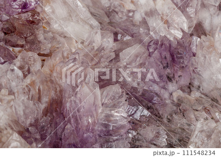 Macro of amethyst mineral stone on black background 111548234