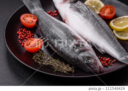 Fresh raw ocean sea bass fish with salt, spices and herbs Fresh raw ocean sea bass fish with salt, spices and herbs 111548429