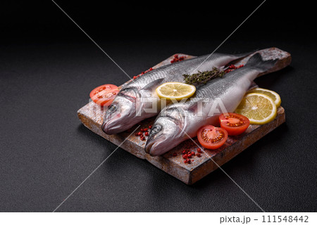 Fresh raw ocean sea bass fish with salt, spices and herbs 111548442