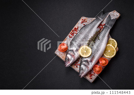 Fresh raw ocean sea bass fish with salt, spices and herbs Fresh raw ocean sea bass fish with salt, spices and herbs 111548443