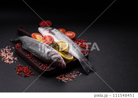 Fresh raw ocean sea bass fish with salt, spices and herbs 111548451