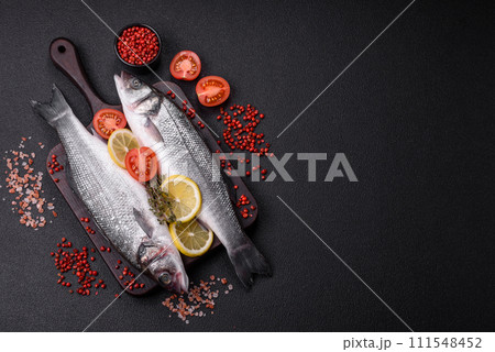 Fresh raw ocean sea bass fish with salt, spices and herbs 111548452