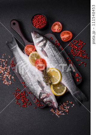 Fresh raw ocean sea bass fish with salt, spices and herbs 111548453