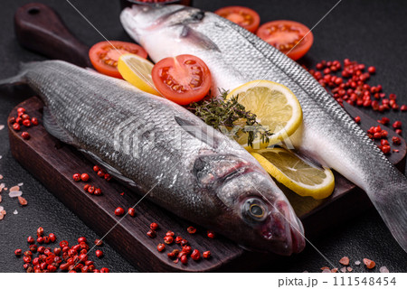 Fresh raw ocean sea bass fish with salt, spices and herbs 111548454