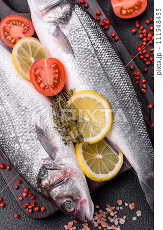 Fresh raw ocean sea bass fish with salt, spices and herbs 111548455